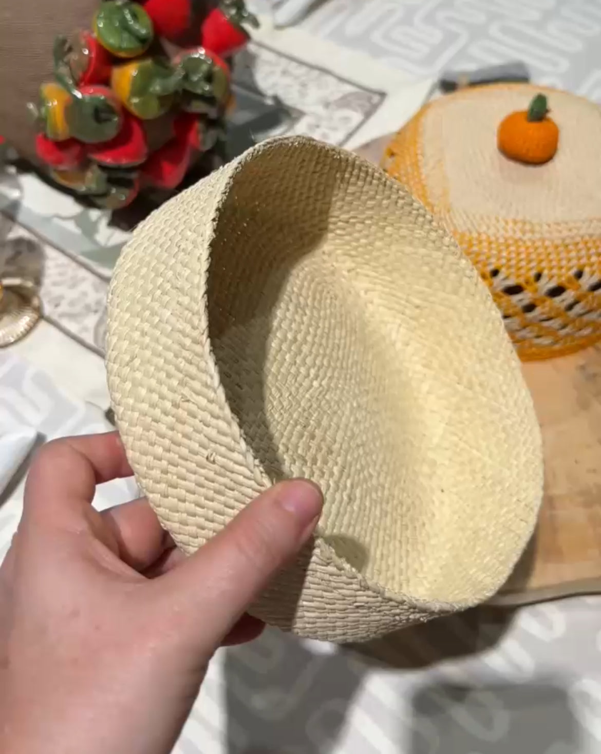 Hand holding a woven basket with a blurred background