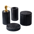 Set of black textured bathroom containers with a gold pump on a light gray background
