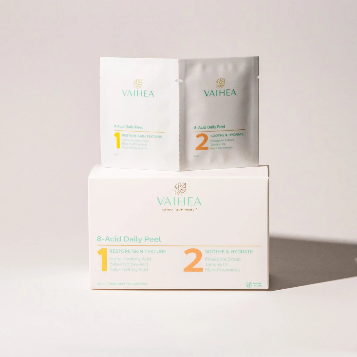 Vaihea skincare products including a box, packets, and a sheet on a light gray background