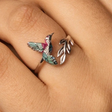 Ring with a hummingbird design on a finger