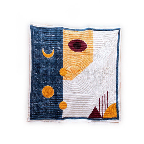 Quilt with abstract geometric design on a white background