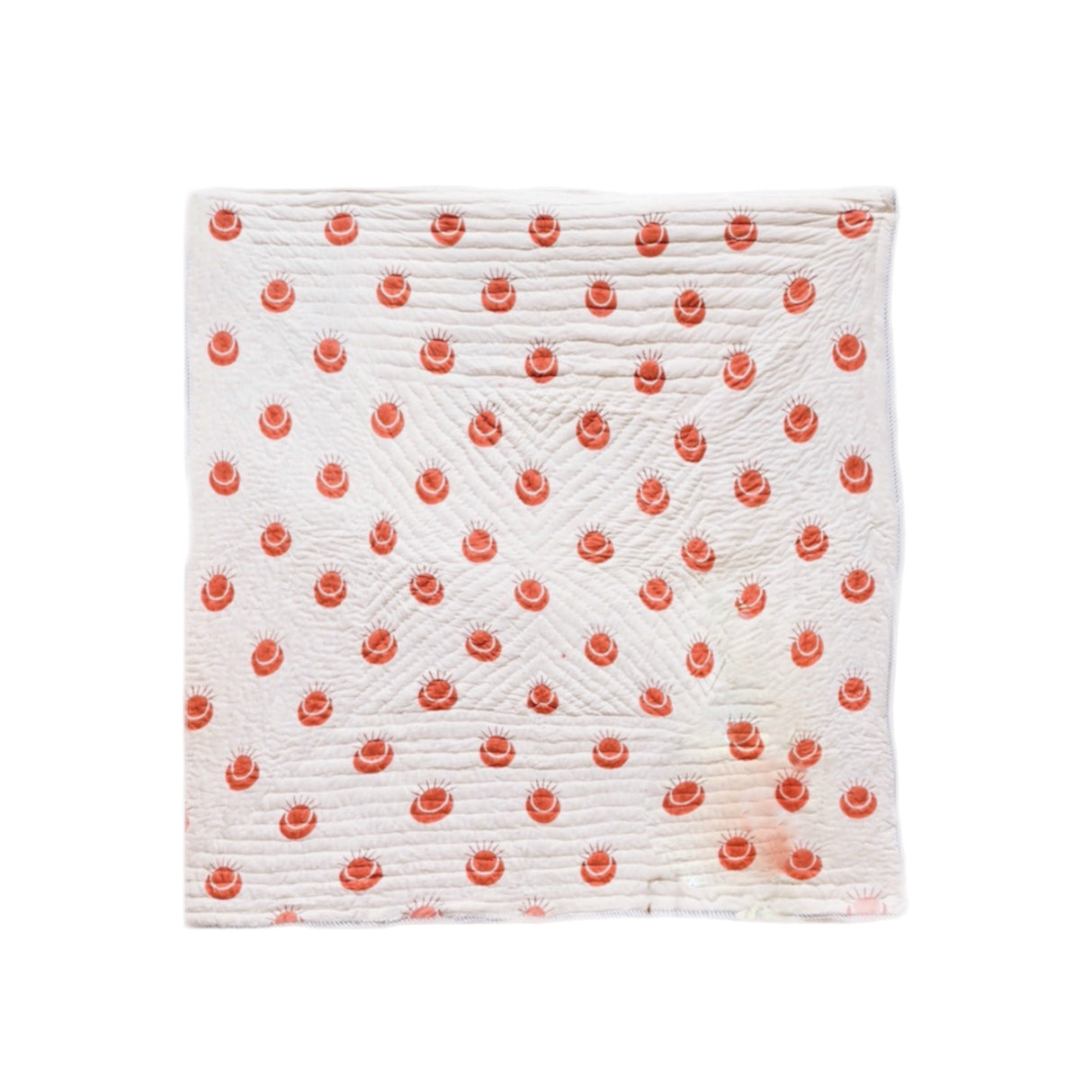 White quilt with red floral pattern on a white background