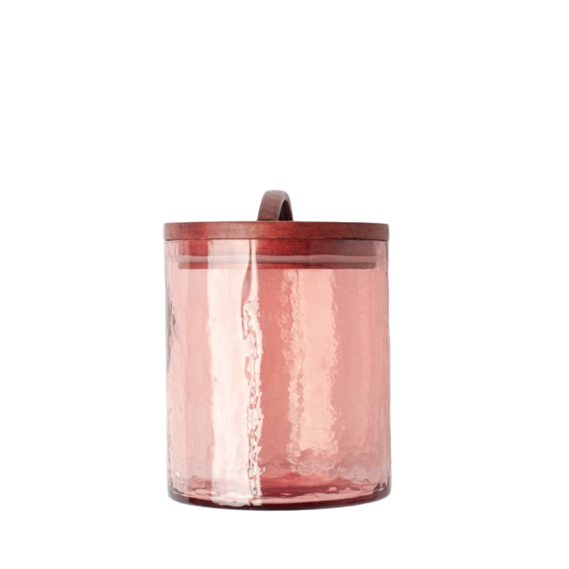 Pink glass jar with wooden lid on a white background