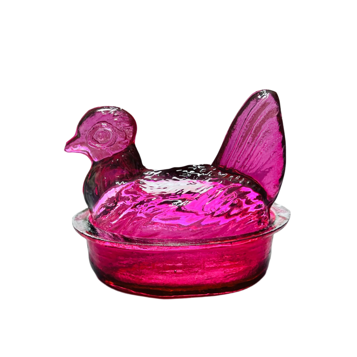 A hand blown glass nesting hen bowl and lid in magenta color.