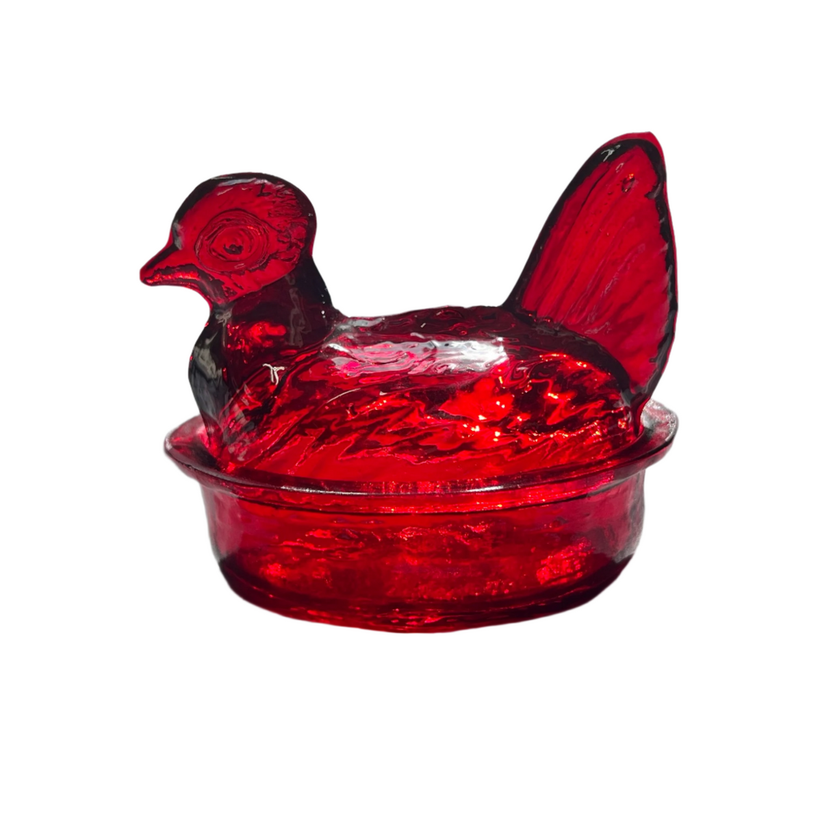 A hand blown glass nesting hen bowl and lid in a ruby red color.