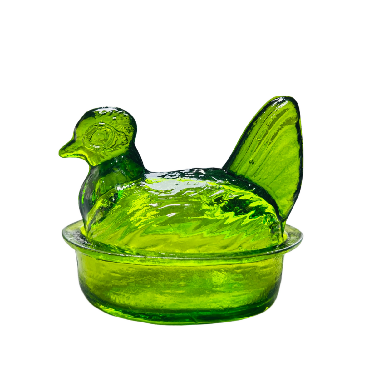 A hand blown glass bowl in the shape of a nesting hen, with a lid, in an olive green color.