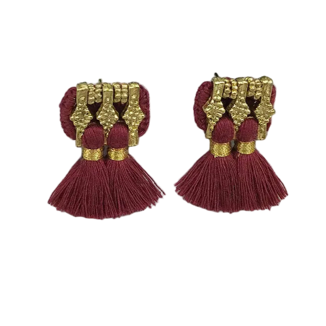 Pair of tassel earrings with gold accents and maroon fabric on a white background