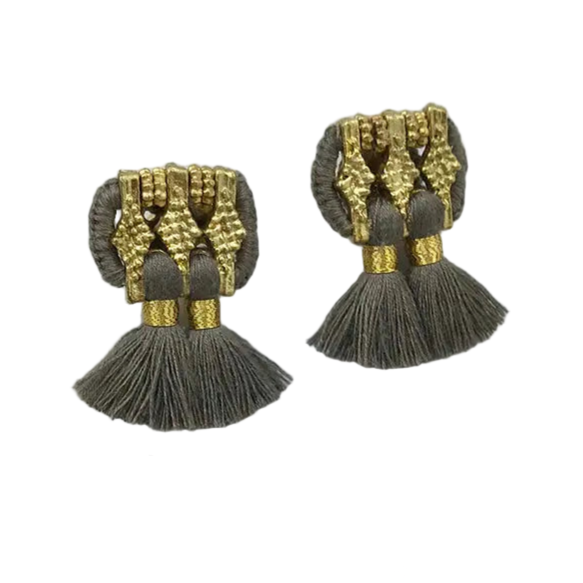 Pair of tassel earrings with gold and red accents on a white background