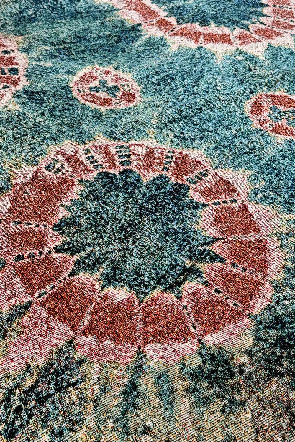 Indigo and burnt orange woven throw blanket with an abstract, hand-dyed look and colorful fringe.