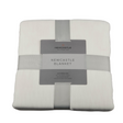 Folded Newcastle blanket with a label on a white background