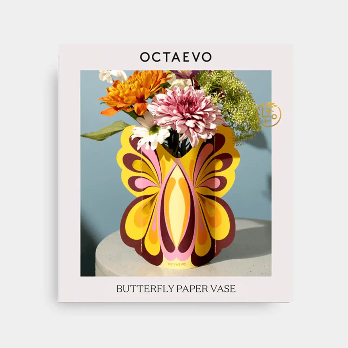 Butterfly paper vase with flowers on a light gray background, featuring the brand 'Octaevo'.
