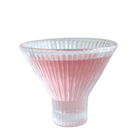 Clear glass vase with pink ribbed design on a white background