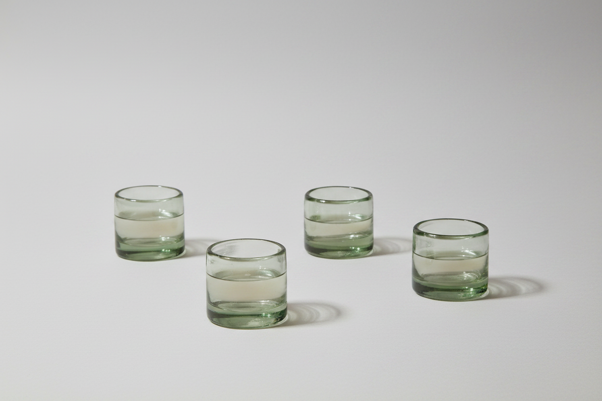 Four glass tumblers on a white background