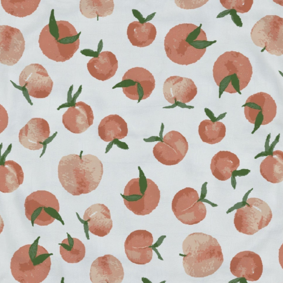 Patterned fabric with peach design on a white background
