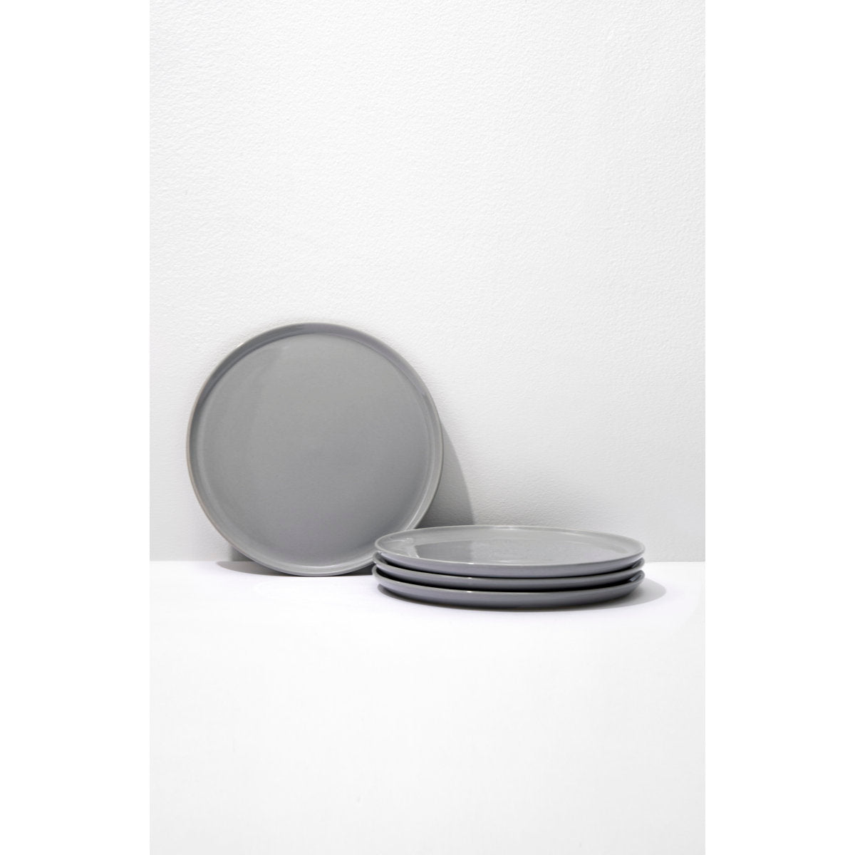 Set of gray ceramic plates on a white background