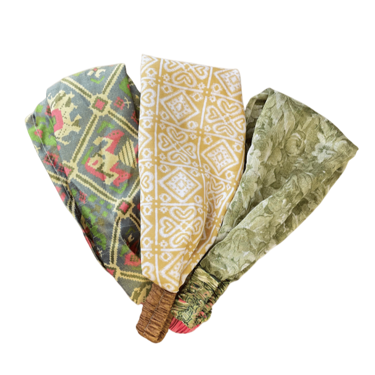 Set of three patterned headbands on a white background