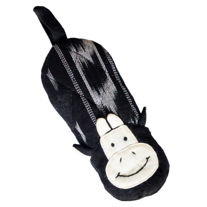 Black and white cow skillet handle holder with a plain background
