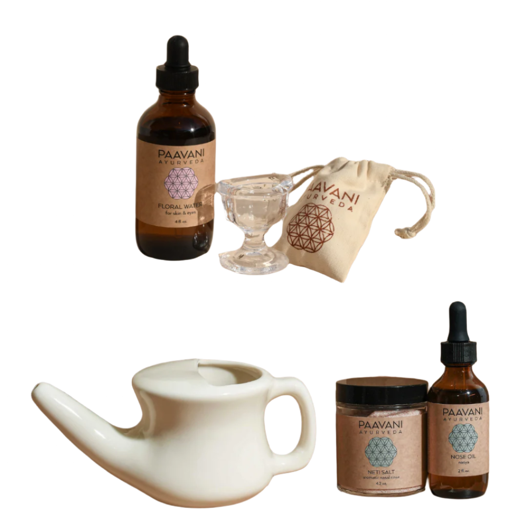 Set of Paavani Ayurveda products including a bottle, jar, dropper, and neti pot on a white background.