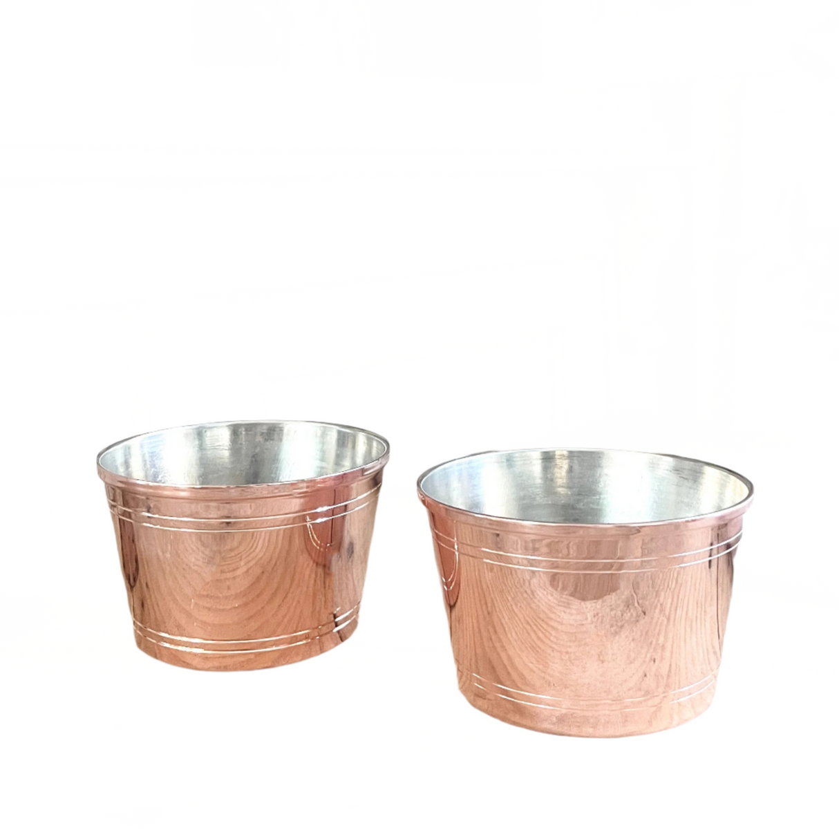 Two copper planters with a silver interior on a white background