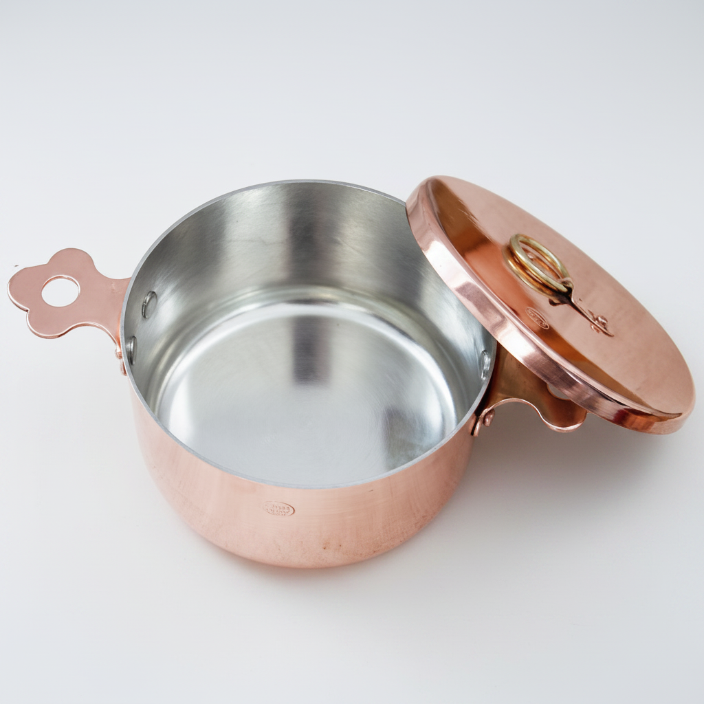 Copper pot with a lid on a white background
