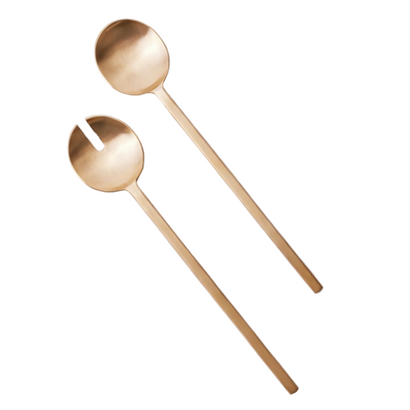 Two gold spoons on a white background