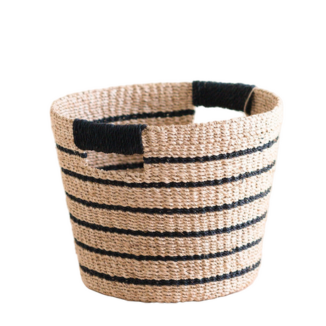 Woven basket with black stripes and a black handle on a white background