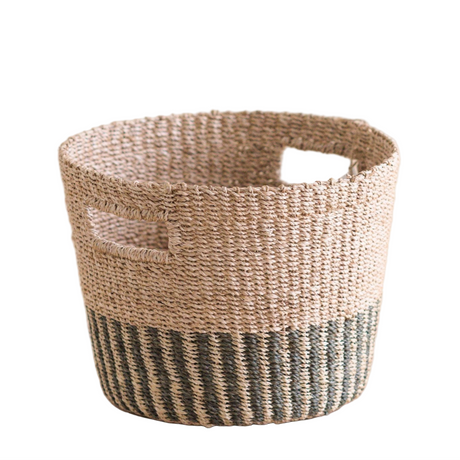 Woven basket with natural and black striped design on a white background
