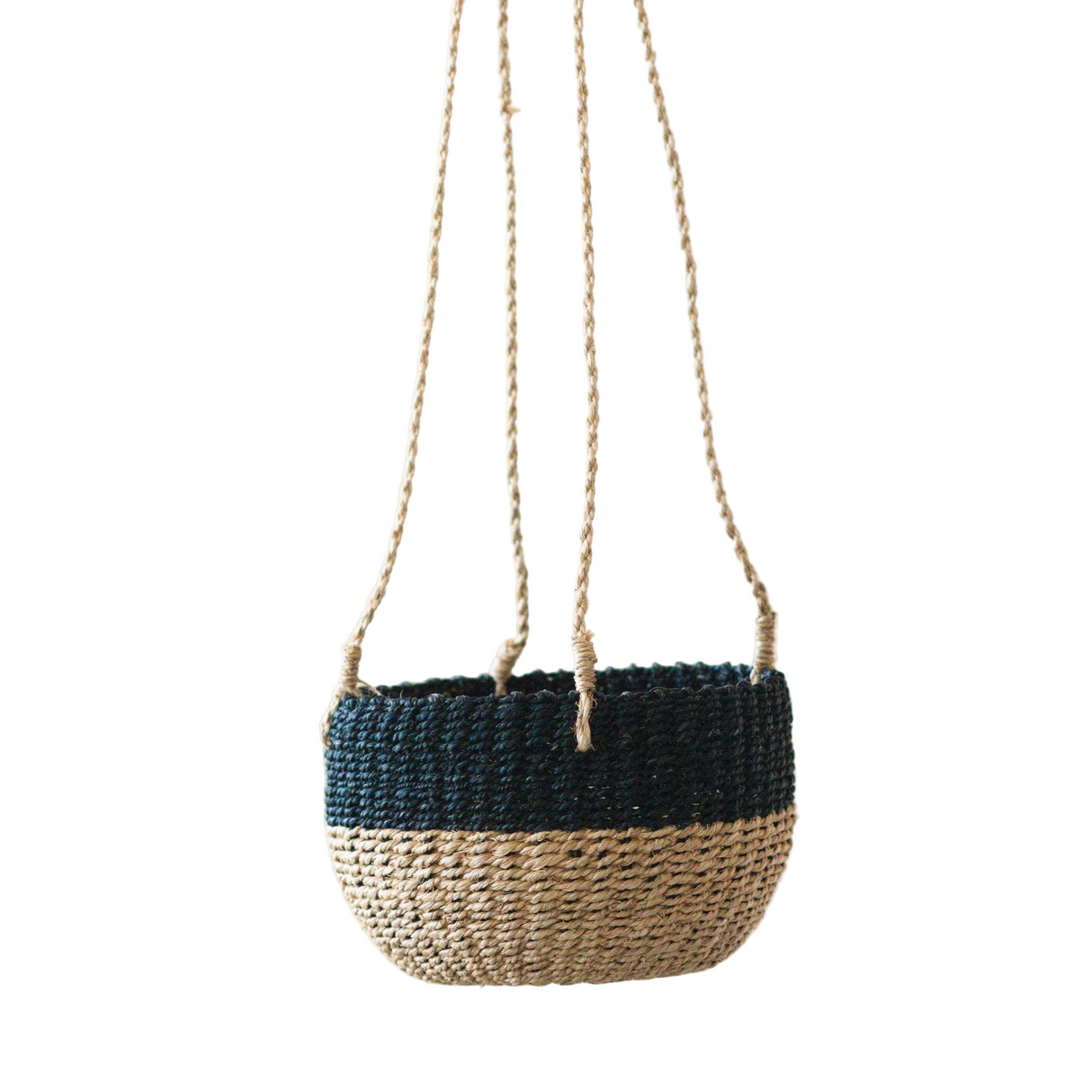 Woven basket with black top and natural bottom hanging on a white background