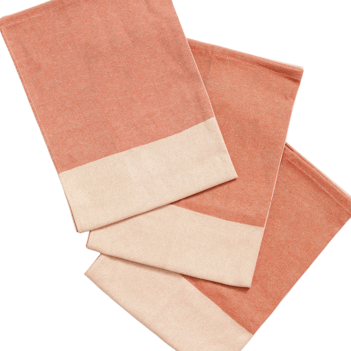 Set of three folded towels in terracotta and beige colors on a white background