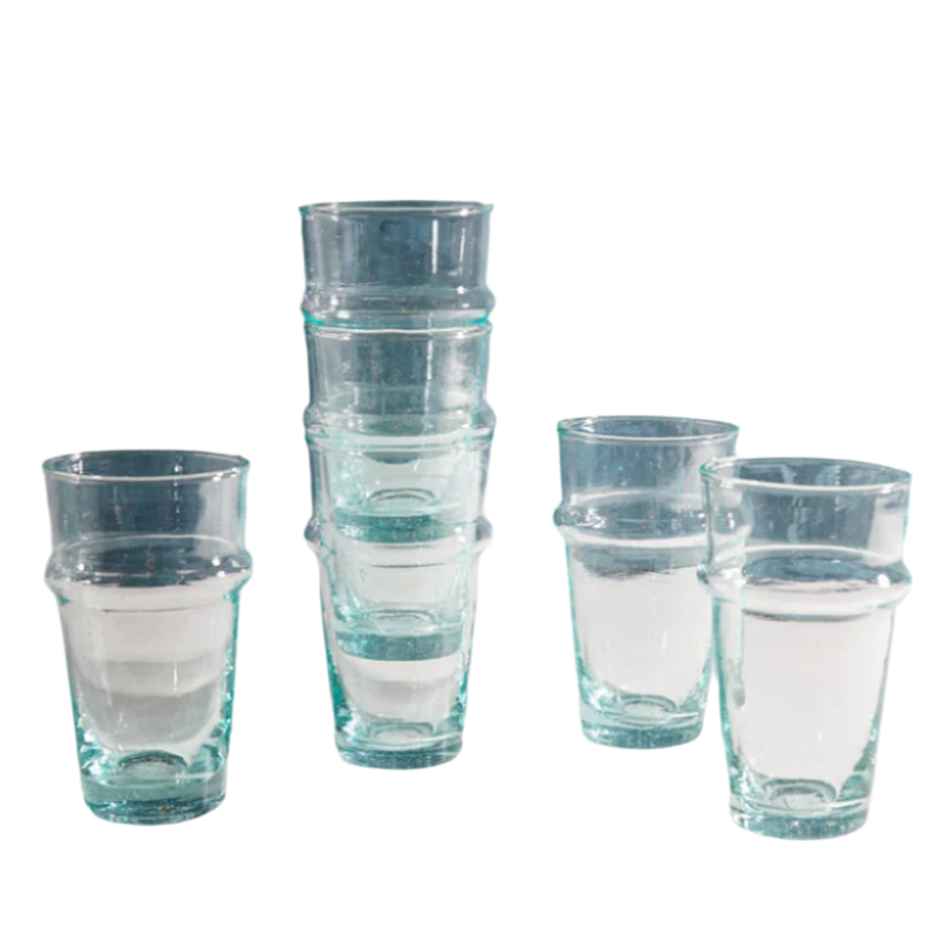 Set of clear glass tumblers with blue rim on a white background