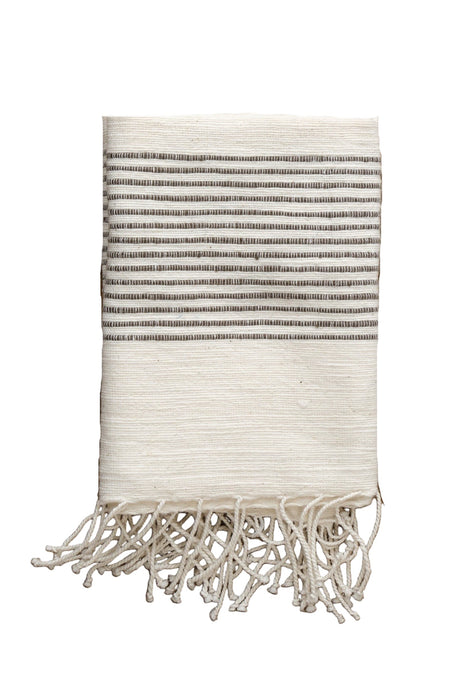 Textile with striped pattern and tassels on a white background