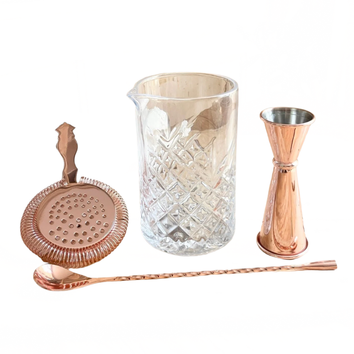 Set of cocktail-making tools including a strainer, jigger, and glass on a white background
