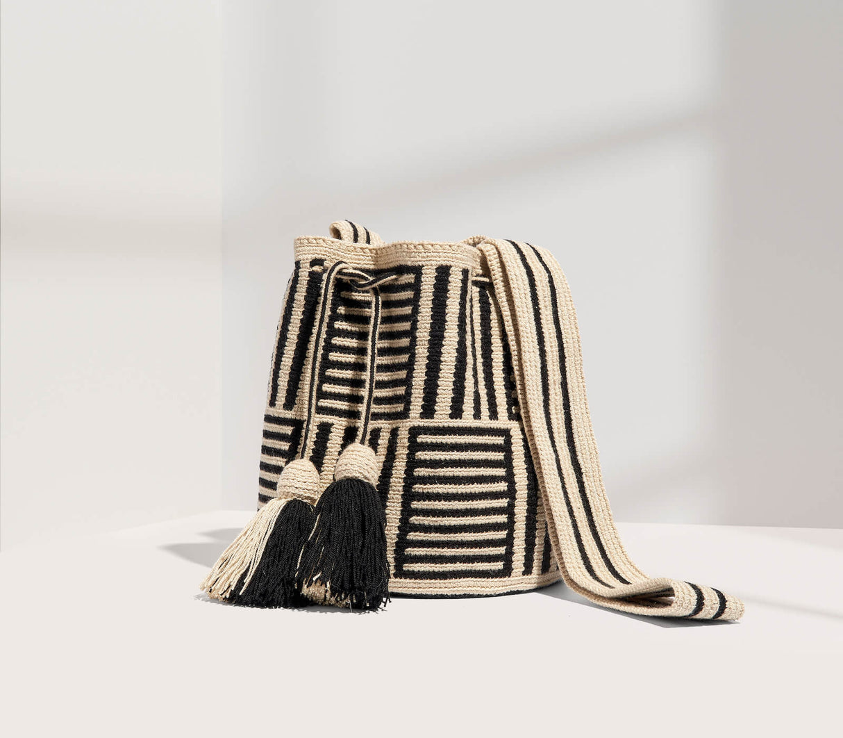 Woven bag with black and white pattern on a light gray background