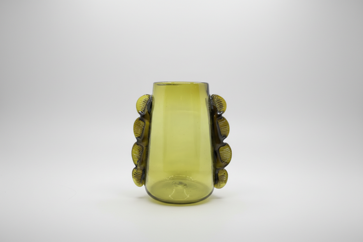 Green glass vase with decorative elements on a white background