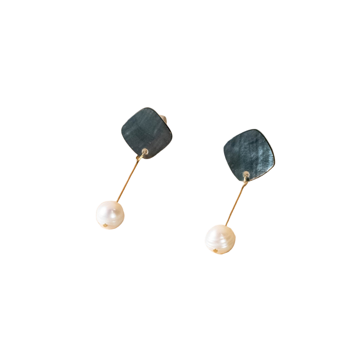 Pair of earrings with green stone and pearl on a white background