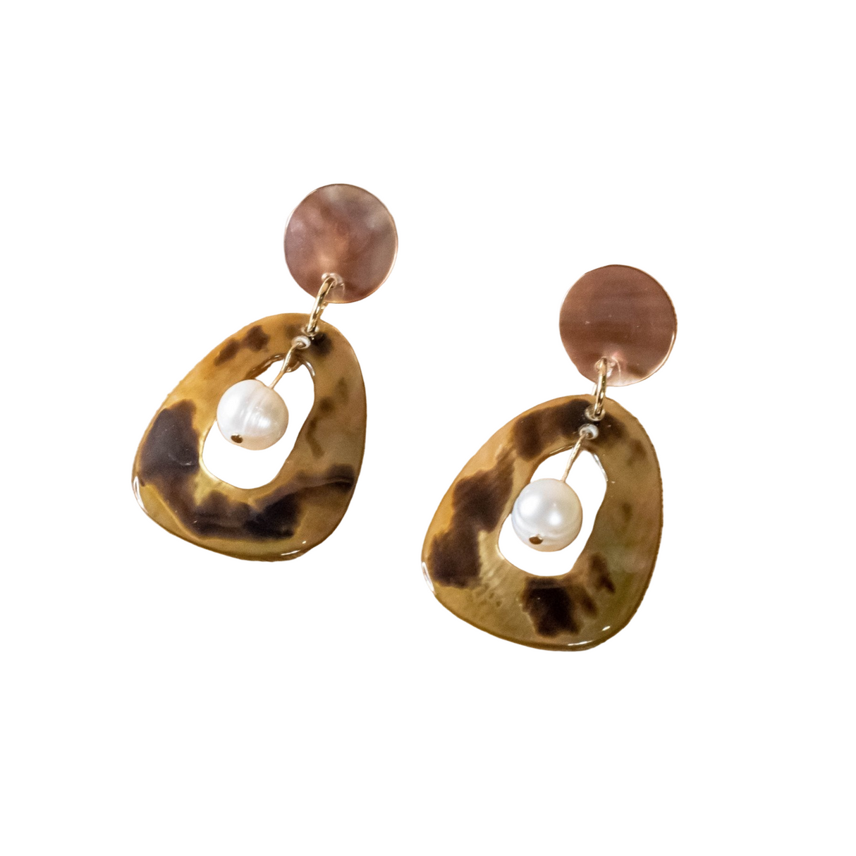 Pair of tortoiseshell earrings with pearl center on a white background