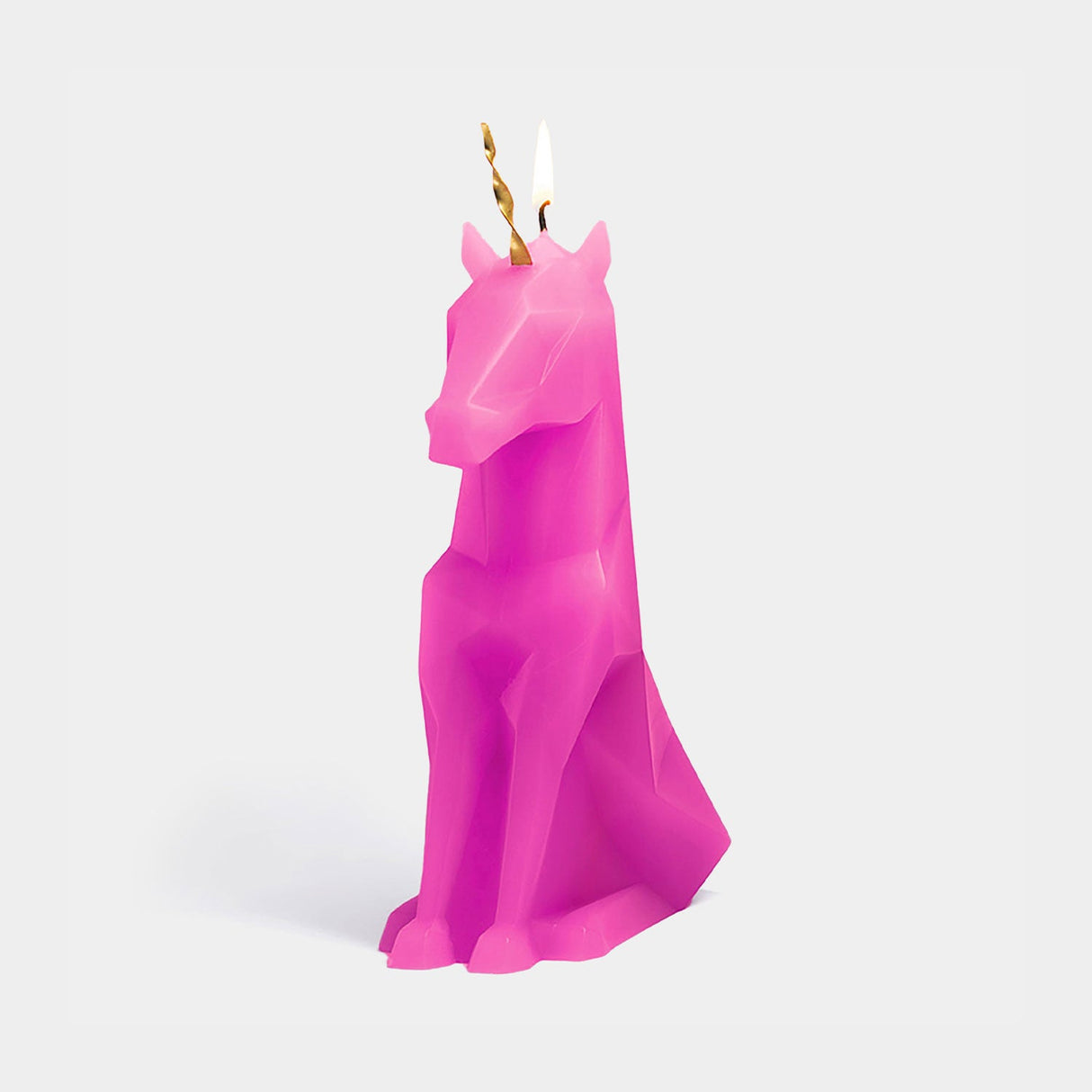 Pink unicorn candle on a white background