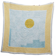 Quilt with a yellow circle and blue pattern on a white background