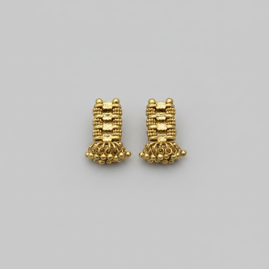 Pair of gold earrings on a gray background