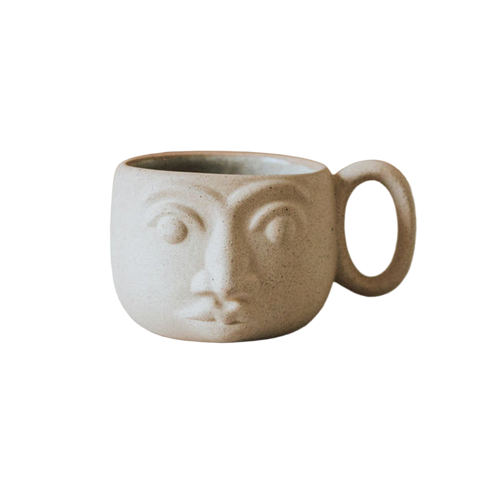 Ceramic mug with face design on a white background