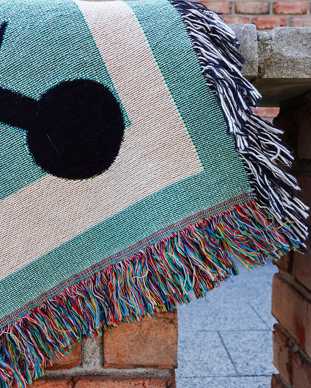 Galactic Muse Alien Cotton Woven Throw Blanket showcasing an alien art design in green, tan, and black.