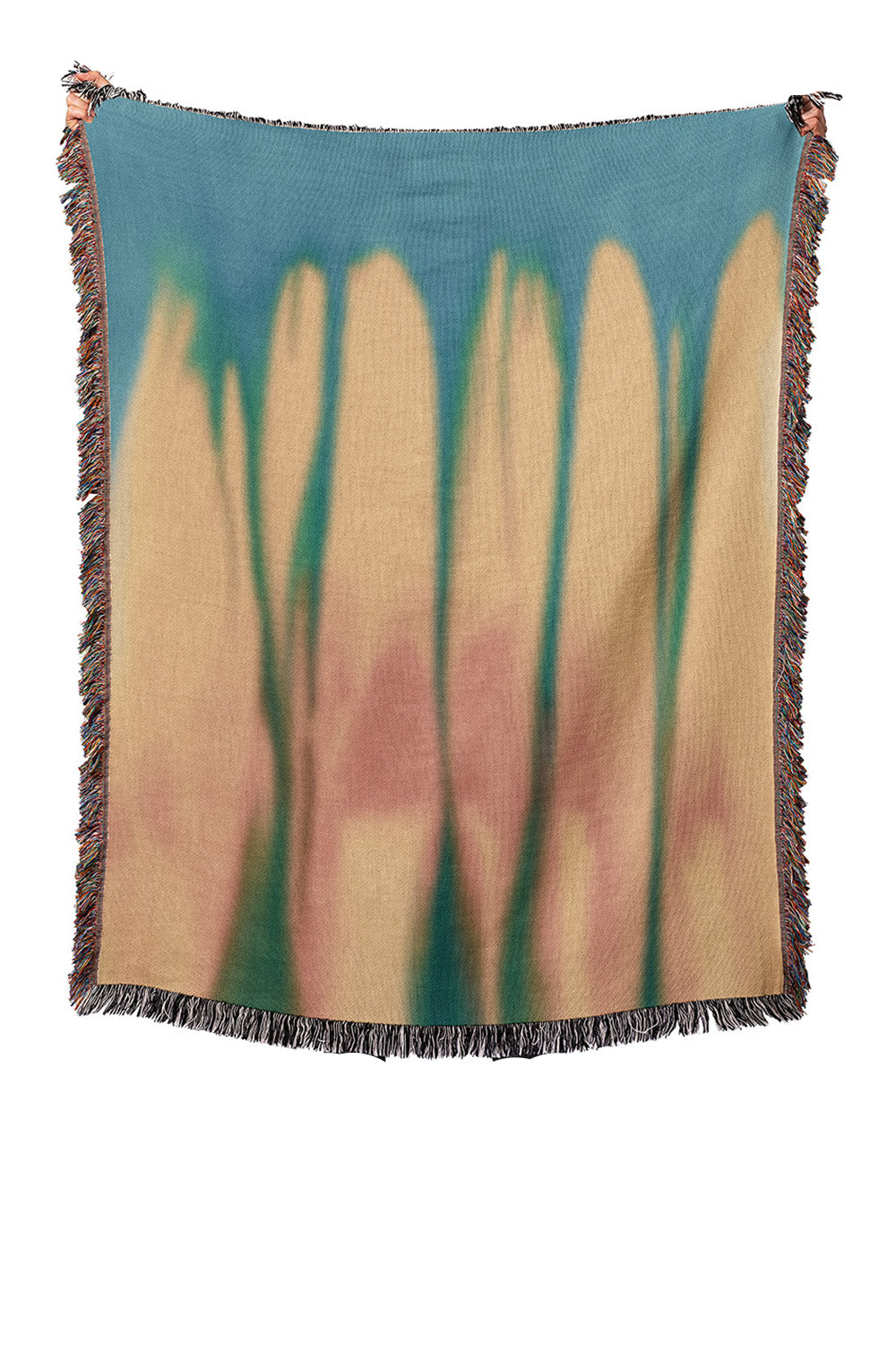 Woven blanket with abstract design of tall grasses on a blue background