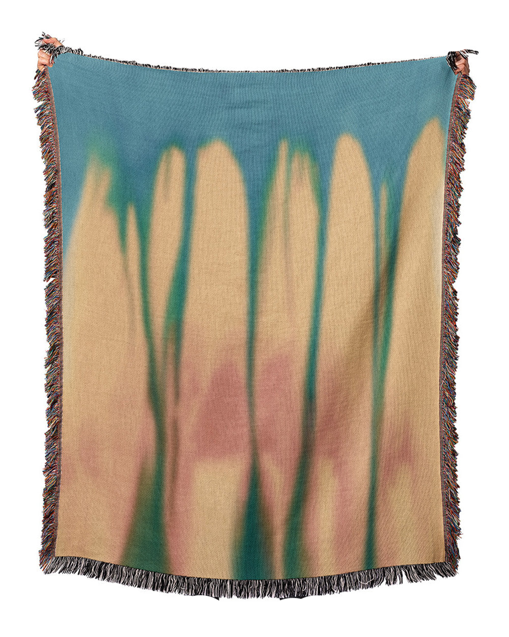 Woven blanket with abstract design of tall, thin shapes in brown and green on a white background