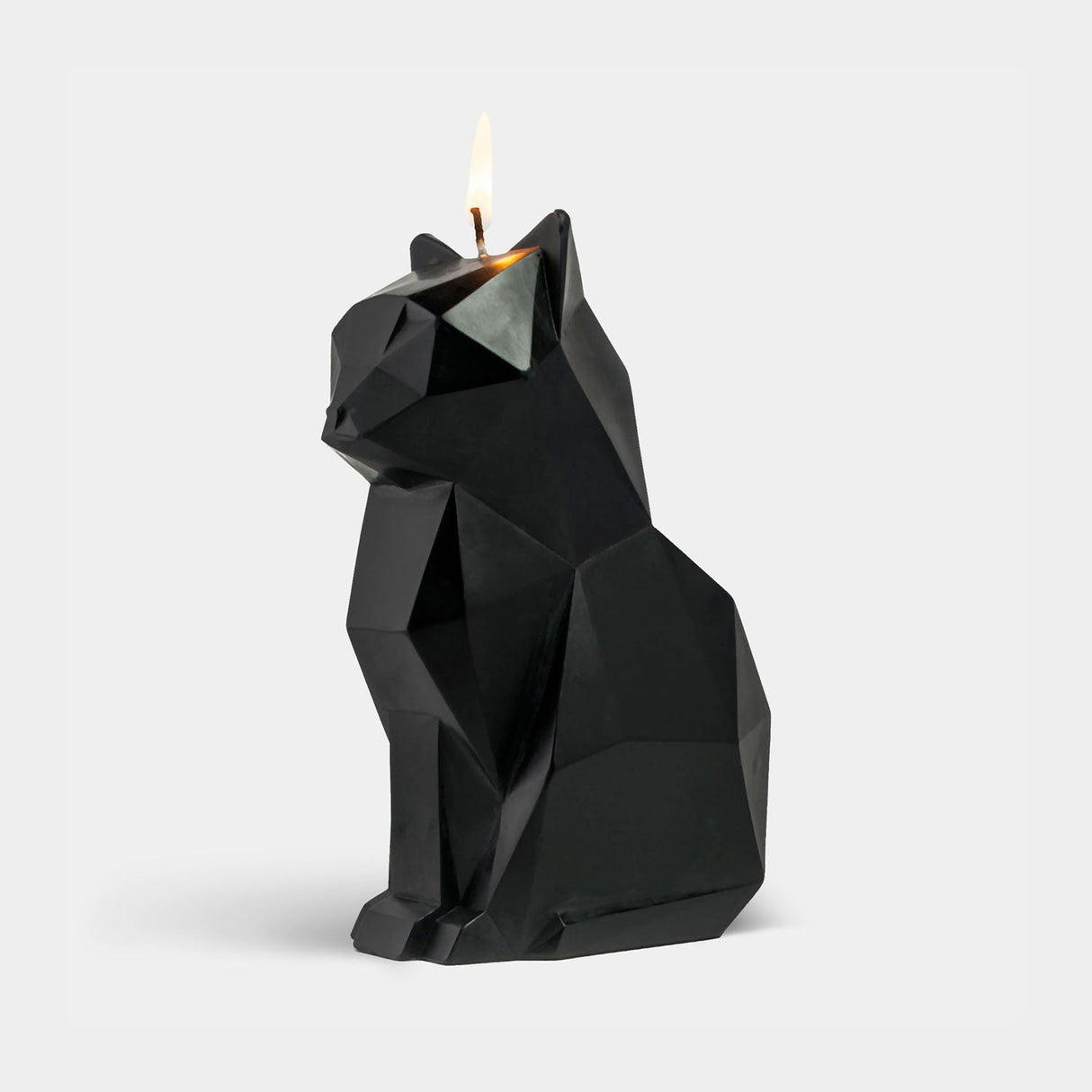 Black cat-shaped candle on a white background