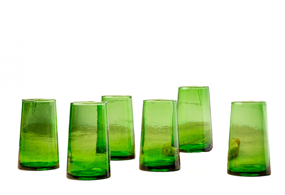 Set of six green glass tumblers on a white background