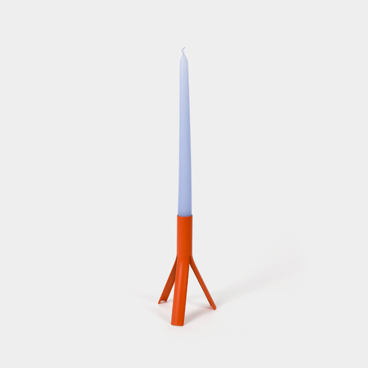 Candle with a blue top and orange base on a white background