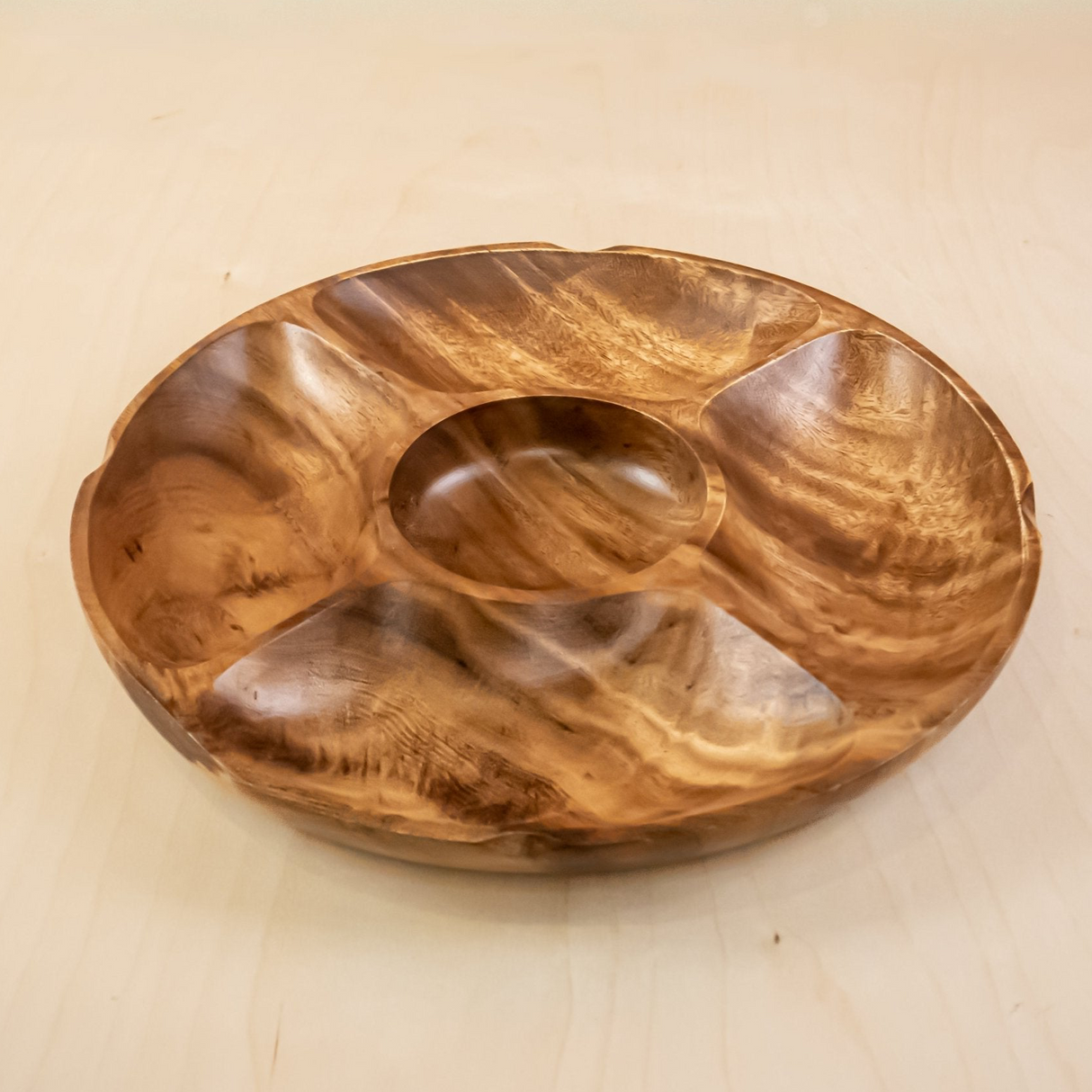 Wooden bowl with divided sections on a beige background
