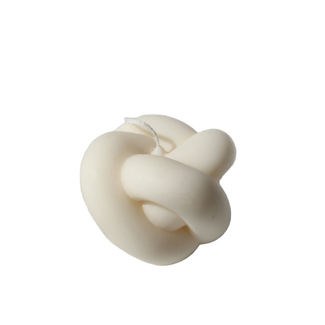 White knot-shaped candle on a white background