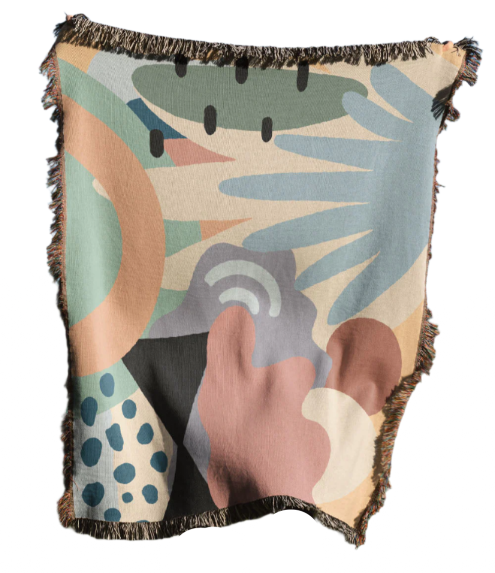 Abstract patterned blanket with fringe on a white background