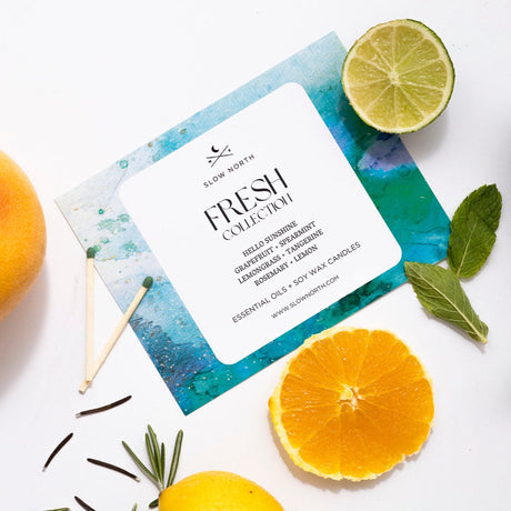 Product packaging for 'Fresh Collection' essential oils with fruits and leaves on a white background
